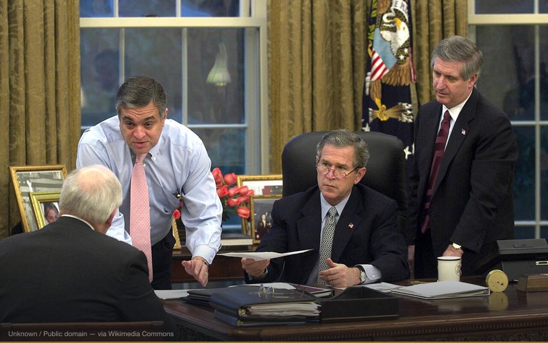 George Tenet (left, in pink tie) gives a briefing to George W. Bush. From official White House site. [1] — related to 9/11 Advance Knowledge — Who Knew?