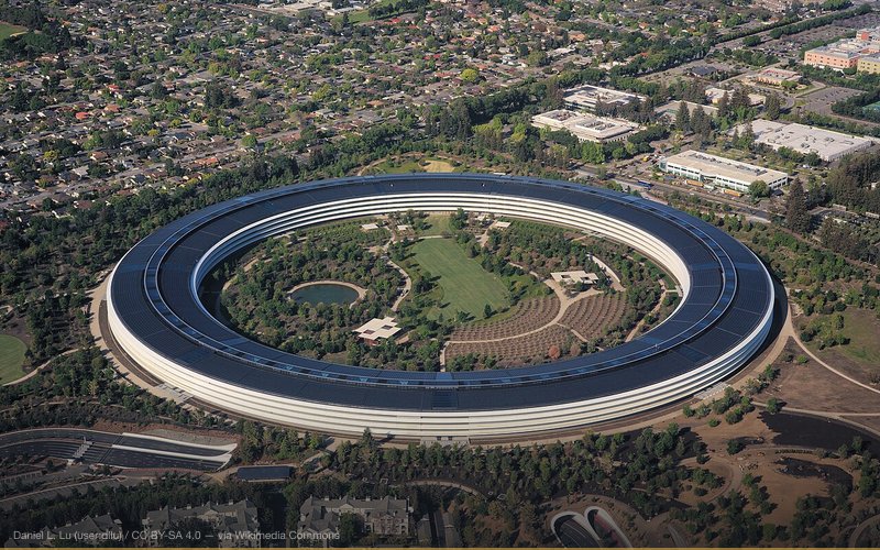 Aerial view of Apple Park, the corporate headquarters of Apple Inc., located in Cupertino, California. The roof is covered in solar panels with an output of 17 MWp, making it one of the biggest solar roofs in the world. Photo taken from a Cessna 172M. — related to Apple iPhone Slowdown / Batterygate
