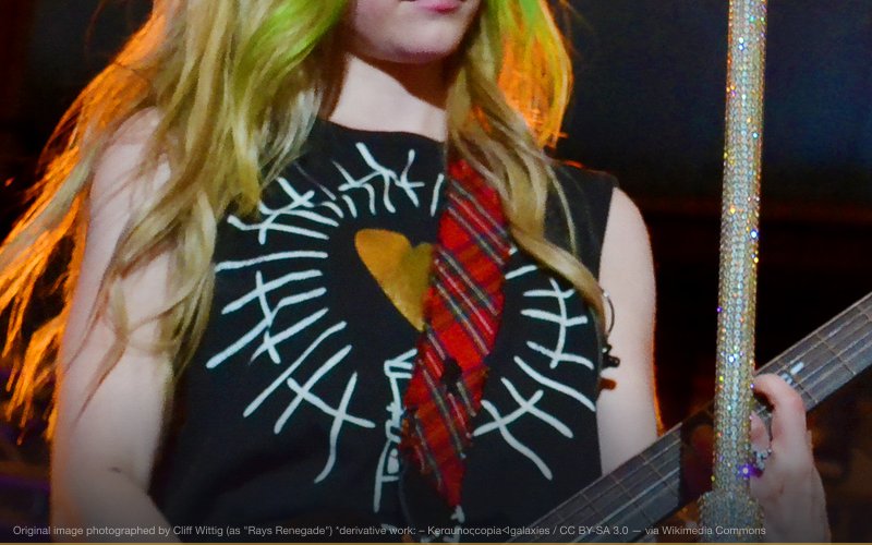 Avril Lavigne playing the guitar on stage during her Black Star Tour on May 28, 2011. The venue is the Tropicana Field stadium in St. Petersburg, Florida, during the Rays/Hess Express Saturday Concert Series. Photographed on a Nikon D3100. — related to Avril Lavigne Was Replaced
