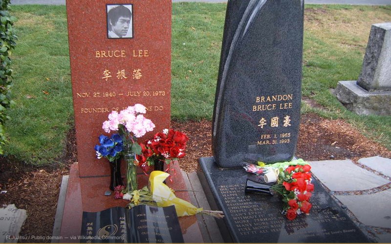 Bruce Lee's headstone along with his son's, Brandon Lee, who died from a bullet firing accidentally during the filming of the movie The Crow. — related to Bruce Lee Was Murdered