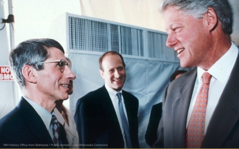 President Bill Clinton visits the NIH in 1999 and hears about the latest advances in HIV/AIDS research from Dr. Anthony Fauci, NIAID. Credit: NIH Photographer — related to COVID-19 Conspiracy Theories (Overview)