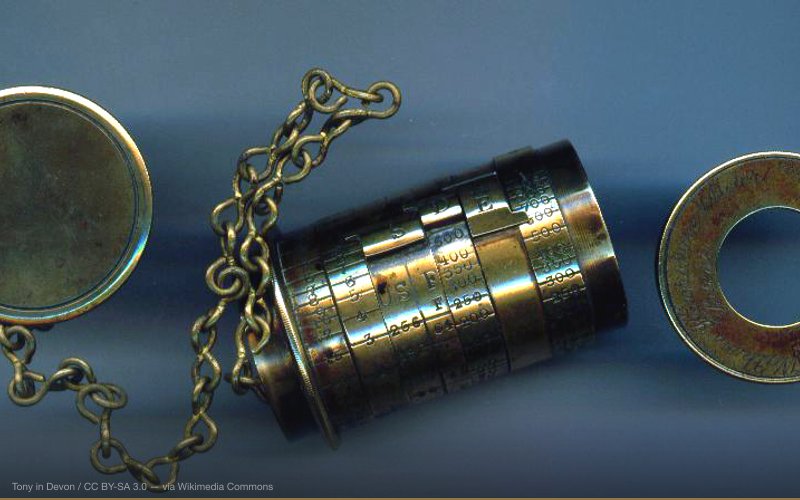 Watkins Exposure Meter with one-second pendulum timing chain attached to removable cover at one end, rotatable rings around cylinder to calculate aperture, time, etc, and removable cover at other end to retain coil of light-sensitive paper, with slit to pull out in stages. Engraved 'Watkins Exposure Meter - Patent - Sole Makers R. Field and Co. Birmingham'. Note: this is not the later Watkins 'Bee' Meter, which was similar in appearance to a pocket watch. — related to Crop Circles at Sacred Site Nodes — Earth Energy Theory