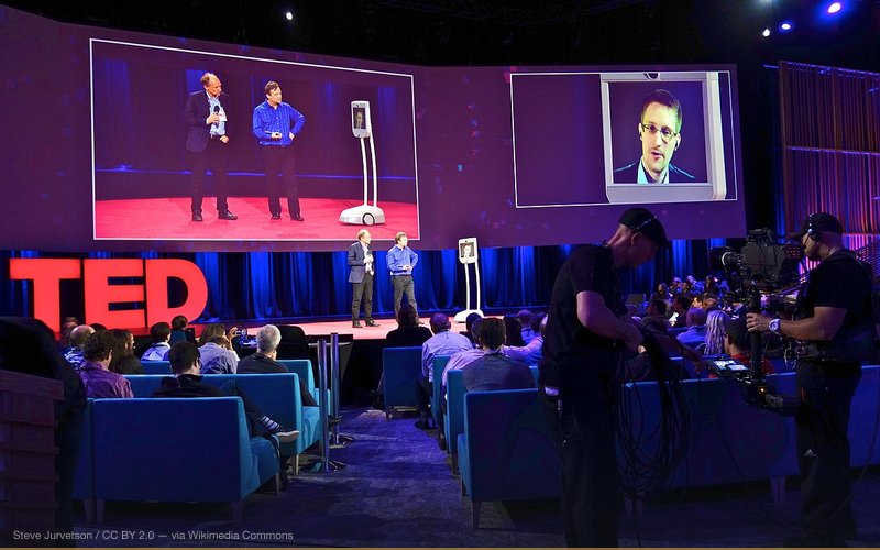 Speaking with Chris Anderson and Tim Berners Lee on a telepresence robot, beaming in from a secret location in Russia. The video is online, and more photos below Some of his zingers: I am living proof that an individual can go head to head against the most powerful agency in the world and win. Democracy may die behind closed doors. We don’t have to give up privacy to have good government, we don’t have to give up liberty to have security. Boundless Informant is a program the NSA hid from Congress. It tells us that more communications are being intercepted in America about Americans than there are in Russia about Russians. I’m not sure that’s what an intelligence agency should be aiming for. Dick Cheney is really something else. The public interest is not always the same as the national interest. At the NSA, "terrorism" is used as a cover for action. Terrorism provokes an emotional response that allows people to rationalize and authorize programs they wouldn’t have otherwise. They asked for this authority in the 1990s and Congress said no. I grew up in the Internet. Although I never expected to have the chance to defend it in such a direct and practical manner, or to embody it in this unusual, avatar manner, there’s something poetic about it. (Facing Tim Berners Lee on stage): A Magna Carta for the Internet is exactly what we need to encode values not just in writing but in the structure of the Internet. PRISM is about content. It deputizes corporate America to do the dirty work for the NSA. Even though some companies did resist, they lost. But this was never tried by open court, only by secret court... making secret interpretations of the law. There have been 34,000 warrant requests in 33 years and they only rejected 11 government requests. (Of 1.7 million documents, only a hundred have been shared so far. Is there more to come?). There are absolutely more revelations to come. Some of the most important reporting is yet to come. The biggest thing an Internet company in America can do today without consulting lawyers to protect users worldwide is to enable SSL web encryption on every page you visit. (When asked if he would return to America If given amnesty): Absolutely. There’s really no question. The government has hinted they want some kind of deal, a compromise deal to come back. But I want to make it very clear. I did not do this to be safe. I did this to do what was right. I won’t stop working in the public interest just to benefit myself. — related to Government Cover-Ups — A Documented History