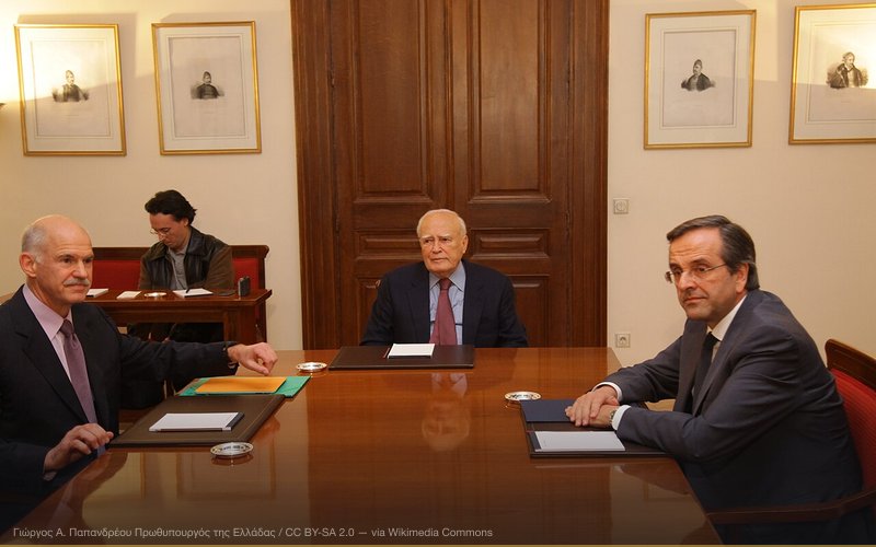 George Papandreou, former Prime Minister of Greece, with Antonis Samaras, leader of the opposition, and Karolos Papoulias, the President of Greece, discussing the details for the formation of a caretaker government in Greece. — related to Greek Debt Crisis Conspiracy