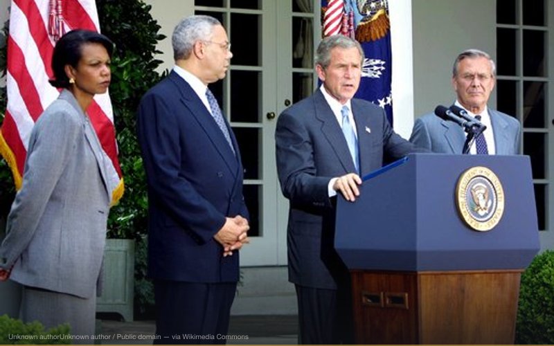 U.S. President George W. Bush (at podium) discusses his plan for peace in the Middle East as National Security Advisor Condoleezza Rice (left), Secretary of State Colin Powell (center) and Secretary of Defense Donald Rumsfeld (right) stand by his side in the White House Rose Garden on June 24, 2002. — related to Iraq WMD Lies — The 'Known Knowns'