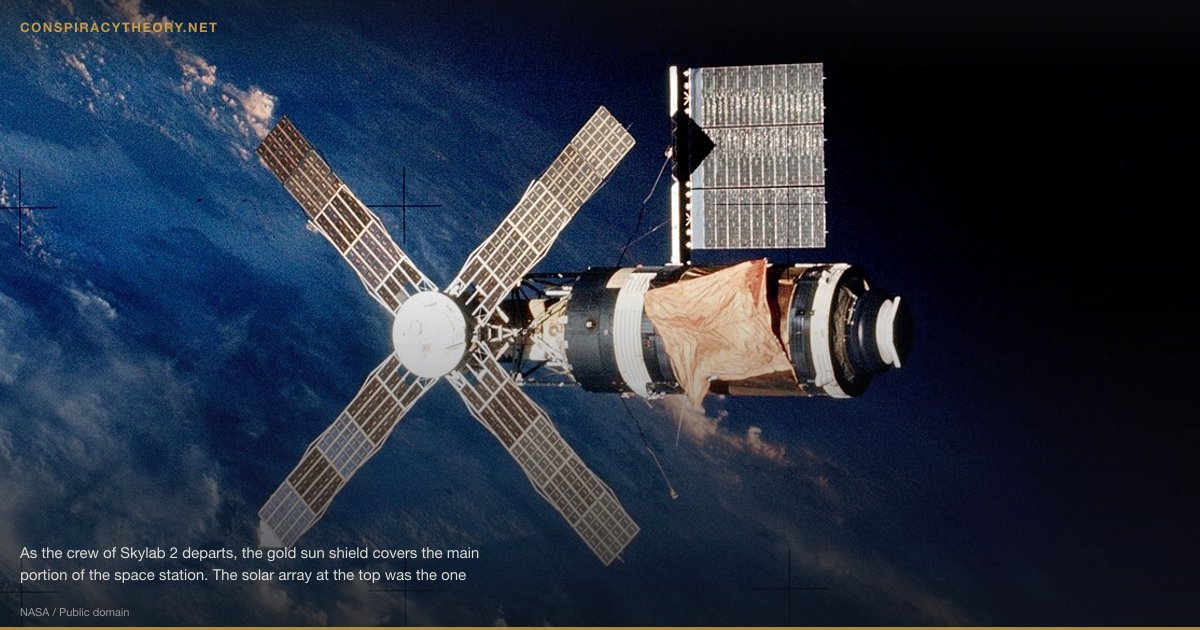 Mars Face & Anomalies Cover-Up (1976-07-25) — As the crew of Skylab 2 departs, the gold sun shield covers the main portion of the space station. The solar array at the top was the one freed during a spacewalk. The four, windmill-like solar arrays are attached to the Apollo Telescope Mount used for solar astronomy.