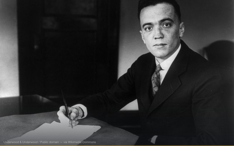 J. Edgar Hoover, half-length portrait, seated at desk, facing left — related to Tesla's Death Ray & Teleforce Weapon