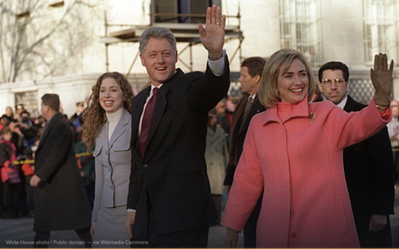 US President Bill Clinton (center with hand up), first lady Hillary Rodham Clinton to right of photo; their daughter Chelsea Clinton to left. On procession in public. The President, First Lady, and Chelsea on parade down Pennsylvannia Avenue on Inauguration day, January 20, 1997. — related to The 'Vast Right-Wing Conspiracy'