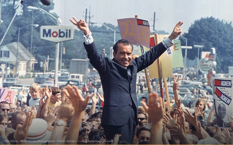 Richard Nixon gives his trademark "victory" sign while in Paoli, PA (Western Philadelphia Suburbs/Main Line) during his successful campaign to become President of the United States — related to Watergate — The Conspiracy That Toppled a President